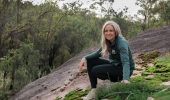 Kate from The Hike Collective on a moss-covered granite trail in Perth Hills