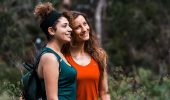 Smiling hikers enjoying a moment on a Perth trail surrounded by native bushland